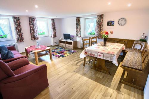 a living room with a couch and a table at Gasthaus-pension zum Löwen in Grafenhausen