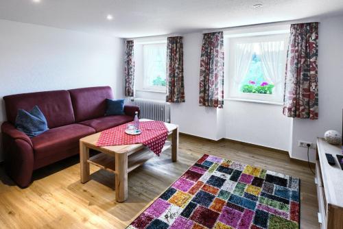 a living room with a couch and a table at Gasthaus-pension zum Löwen in Grafenhausen