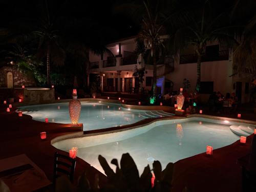 a swimming pool at night with lights in it at Kibanda Natural Kendwa Villa in Kendwa