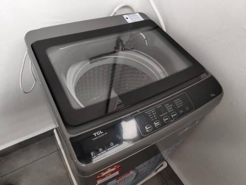 a microwave sitting on top of a counter at Area Indahpura or Taman Bersatu Kulai 3-4BR near AEON Airport JPO in Kulai