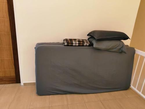 a suitcase with two pillows on top of it at Area Indahpura or Taman Bersatu Kulai 3-4BR near AEON Airport JPO in Kulai