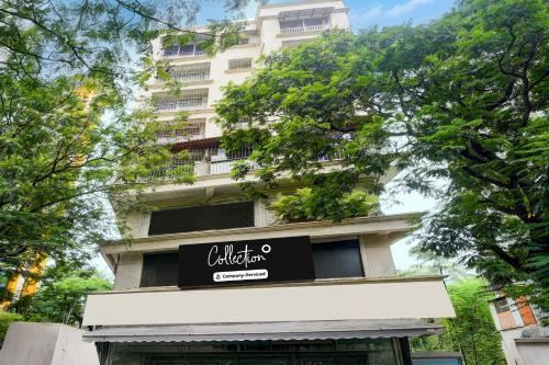 a tall white building with a sign on it at Collection O Viviana Mall Thane West Formerly Athithi Stays in Thane