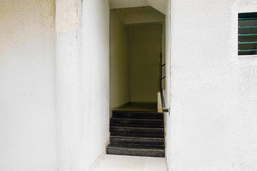 a stairway leading up to a building with a staircase at Collection O Viviana Mall Thane West Formerly Athithi Stays in Thane