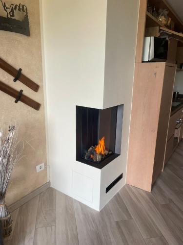 a fireplace in the corner of a living room at Appartamento Lusso Panoramic - Andalo in Andalo