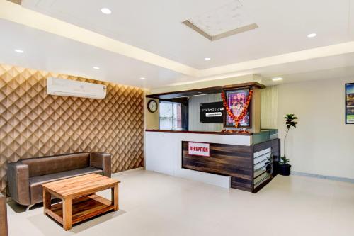 a waiting room with a couch and a table at Super Townhouse Oak Sinhgad Road Crossway Formerly Popular Hotel in Pune
