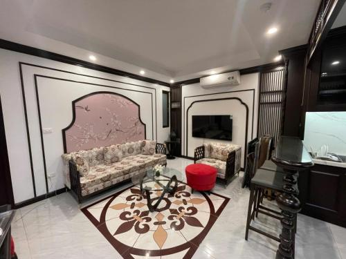 a living room with a couch and a table at WILD LOTUS Apartment HA NOI in Hanoi