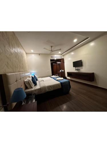 a hotel room with a bed and a television at Hotel The Westinn in Varanasi