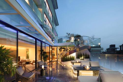 an exterior view of a building with tables and chairs at Tianya Wuxi river Hotel (Jiefangbei ) in Nan'an
