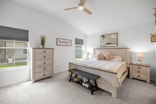 a bedroom with a bed and a dresser and a window at Cozy 2BR With Golfcart 5 Mins to Eastport Sq in Wildwood
