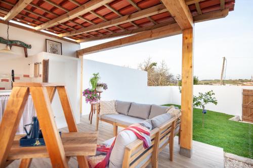a living room with a couch and a table at The Indigo Windmill Retreat in Lourinhã
