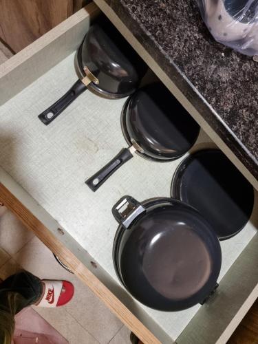 four pots and pans sitting on top of a counter at TheDreamystay dreamy Balcony View in Greater Noida