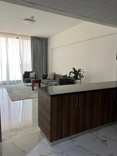 a living room with a couch and a table at Marina Al Hamra in Ras al Khaimah