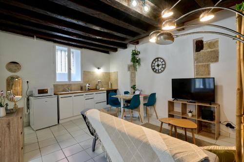 a kitchen and living room with a couch and a table at Studio Solana Hyper center by Primo conciergerie in Nevers