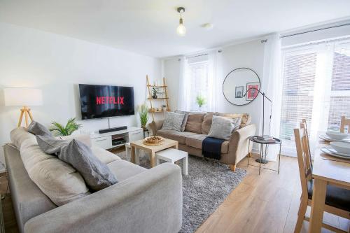 a living room with a couch and a table at Comfortable 4 Bed Modern Townhouse with Parking in Long Eaton