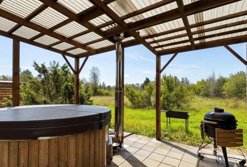 a covered patio with a grill and a grill at Kadaksalu with sauna hinnas in Ruu