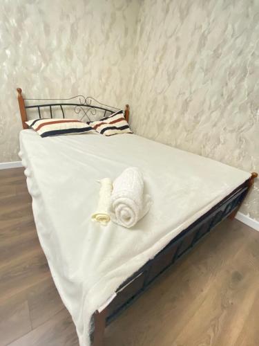 a bed with white sheets and towels on it at Аэропорт Мечеть ЭКСПО in Astana