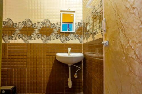 a bathroom with a sink and a mirror at Lakeside Room stay in Yelagiri