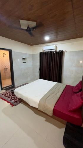 a large bed in a room with a window at Devansh hotel in Kārli