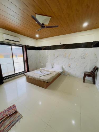 a bedroom with a bed and a ceiling at Devansh hotel in Kārli