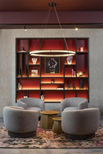 a lobby with chairs and a book shelf at Radisson RED London Twickenham in Twickenham