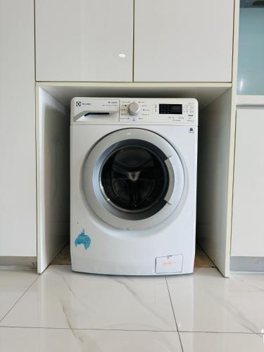 a washing machine sitting in a cabinet in a kitchen at THE PLATINUM KLCC by COZY STAY in Kuala Lumpur
