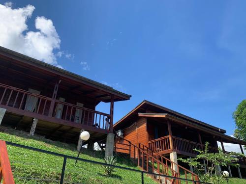 a house on a hill with a fence in front of it at Pandan View Mandeh in Pasarsungai-nyala