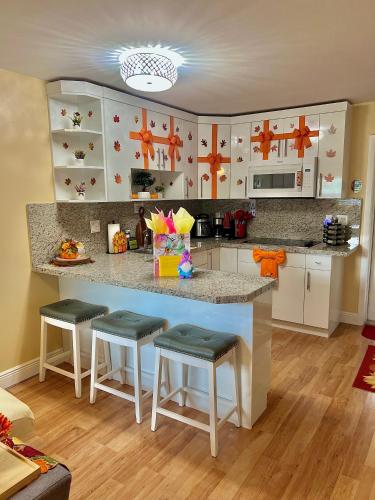 a kitchen with a counter and stools in a room at The Boutique Guest House in Miami