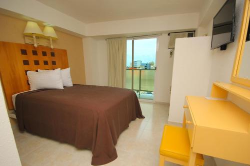 Postel nebo postele na pokoji v ubytování Hotel Posada del Carmen