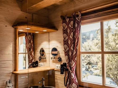 a bathroom with a sink and a window with a view at Ferienparadies Schwarzwälder Hof in Seelbach