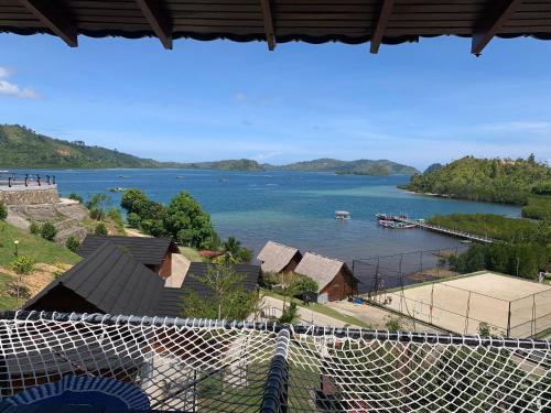a view of a body of water with a harbor at Pandan View Mandeh in Pasarsungai-nyala