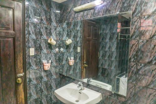 a bathroom with a sink and a mirror at Sword Lake Hostel and Spa in Hanoi