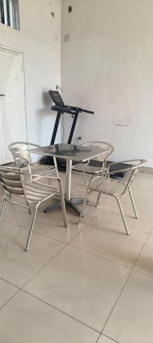 a table and two chairs with a laptop on it at Serene 5-Bedroom Apartment in Kinshasas 10me Rue Limete-Rsidentiel in Lemba-Gaba