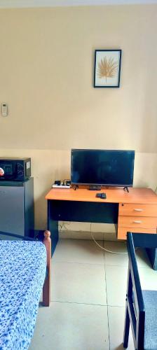 a wooden desk with a laptop on top of it at Serene 5-Bedroom Apartment in Kinshasas 10me Rue Limete-Rsidentiel in Lemba-Gaba