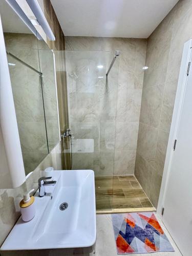 a bathroom with a sink and a shower at Apartment LULU in Bar