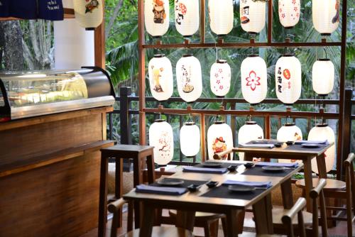 a restaurant with two tables and white plates and utensils at Rawi Warin Resort And Spa - SHA Extra Plus in Ko Lanta