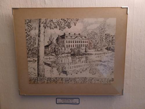 a drawing of a building in a picture on a wall at Brukshotellet Skinnsberg in Skinnskatteberg