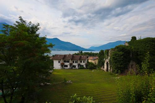 a house in a field with mountains in the background at housecurti1 in Sorico