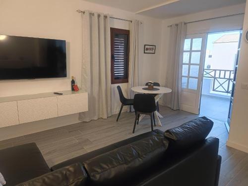 a living room with a couch and a table at Casa Alkama in Playa Honda