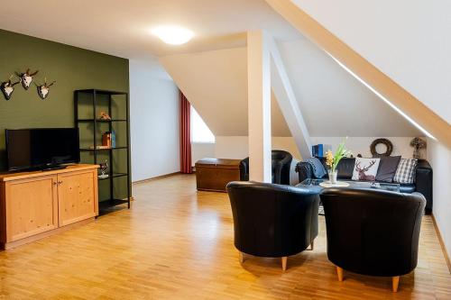 a living room with a couch and a table at Apparthotel Bad Schandau by STEIGER Hotels in Bad Schandau
