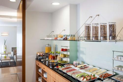 a buffet with various food items on display at NH Frankfurt Messe in Frankfurt/Main