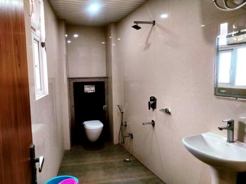 a small bathroom with a toilet and a sink at Hotel RN Residency - Near Prem Mandir Vrindavan in Vrindāvan