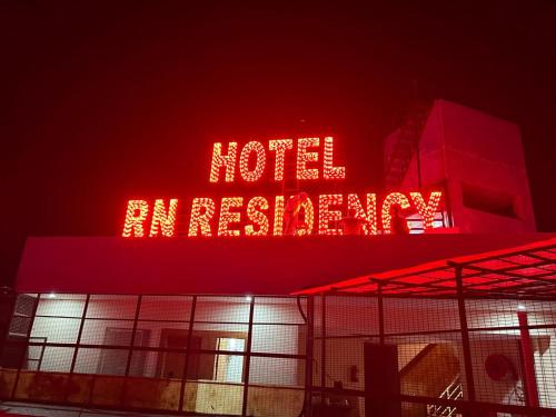 a neon sign on top of a building at night at Hotel RN Residency - Near Prem Mandir Vrindavan in Vrindāvan