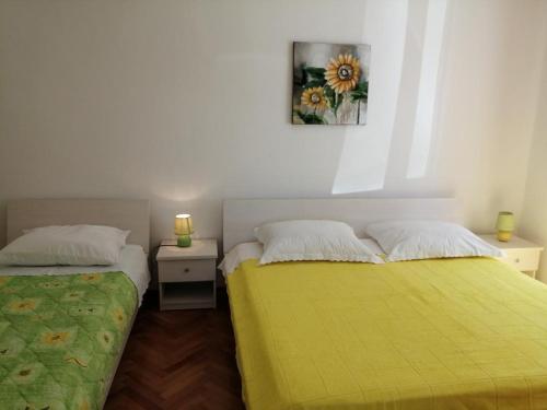 a bedroom with two beds and a picture on the wall at Apartment in Primosten with sea view, balcony, air conditioning, WiFi 5155-1 in Primošten