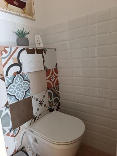 a bathroom with a toilet with tiles on the wall at Apartment in Primosten with sea view, balcony, air conditioning, WiFi 5155-1 in Primošten