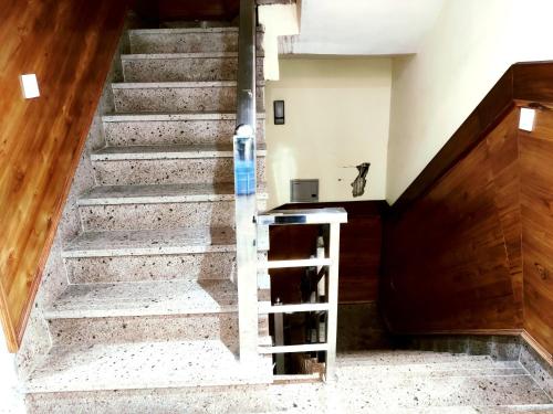 a staircase in a house with a cat sitting on the step at Hotel RN Residency - Near Prem Mandir Vrindavan in Vrindāvan