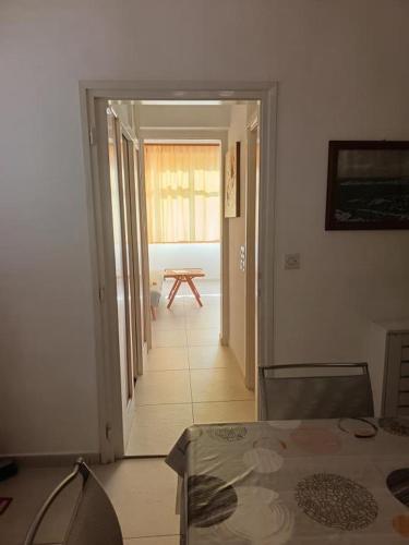 a room with a table and a door to a room with a table at Apartment in Primosten with sea view, balcony, air conditioning, WiFi 5155-1 in Primošten
