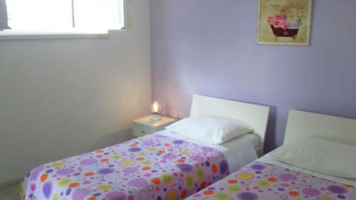 a small bedroom with two beds and a window at Apartment in Primosten with sea view, balcony, air conditioning, WiFi 5155-1 in Primošten