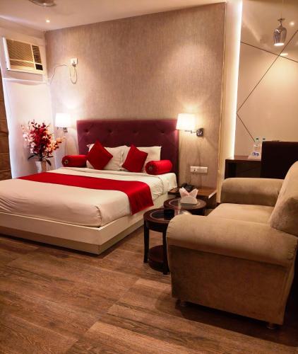 a hotel room with a bed and a couch at Hotel Gurveer Royal in Lucknow