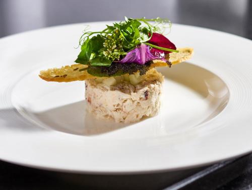 a white plate with a piece of food on it at Wedgewood Hotel & Spa - Relais & Chateaux in Vancouver