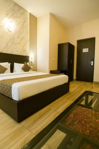 a hotel room with two beds and a glass table at Vrindavan Dreams Suits & Luxury Villas in Vrindāvan